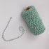Roll of green and white striped butcher string, butcher twine, meat string, meat twine on a light gray background